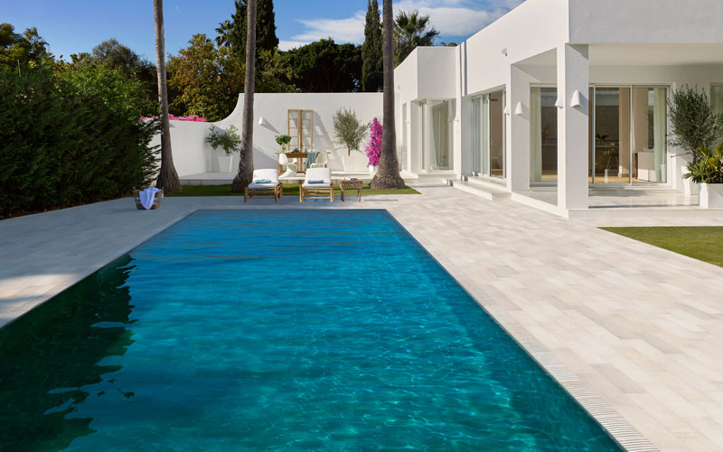 Trésor Bali porcelain stoneware tiles on the pool tank combined with Stela White on the edge
